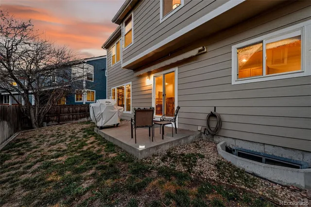 a view of two chairs in the backyard