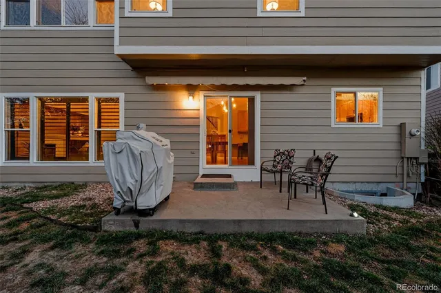 a view of a dinning table and chairs in back of the house