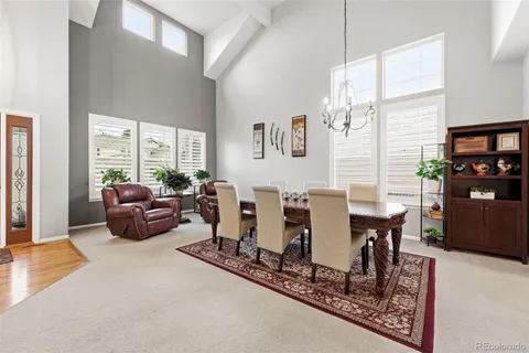a living room with furniture a rug and a large window