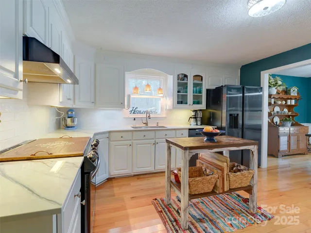 a kitchen with a stove a refrigerator and a sink