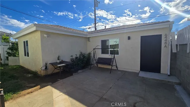 a view of a porch with a table and chairs