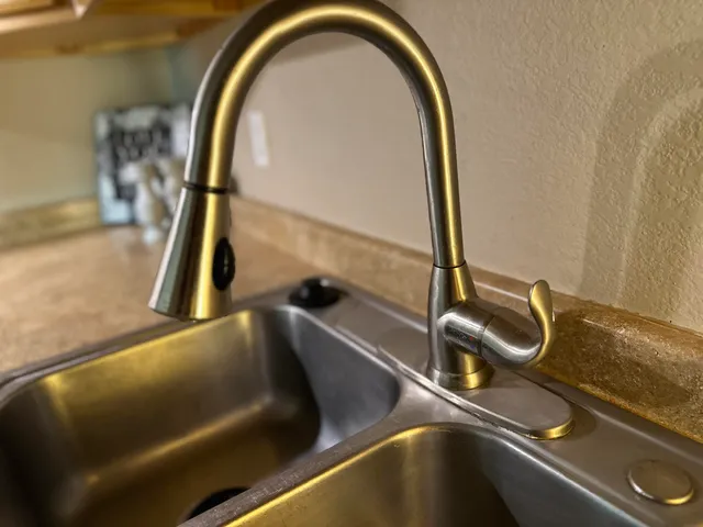 an empty room with a chandelier fan and windows