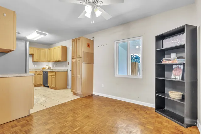 a kitchen with a sink a stove top oven and cabinetry