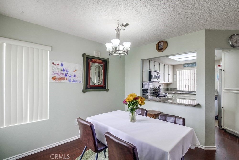 1567 Apache Drive, Unit A Chula Vista, CA 91910 - Photo 11 of 51 a view of a dining room with furniture and chandelier