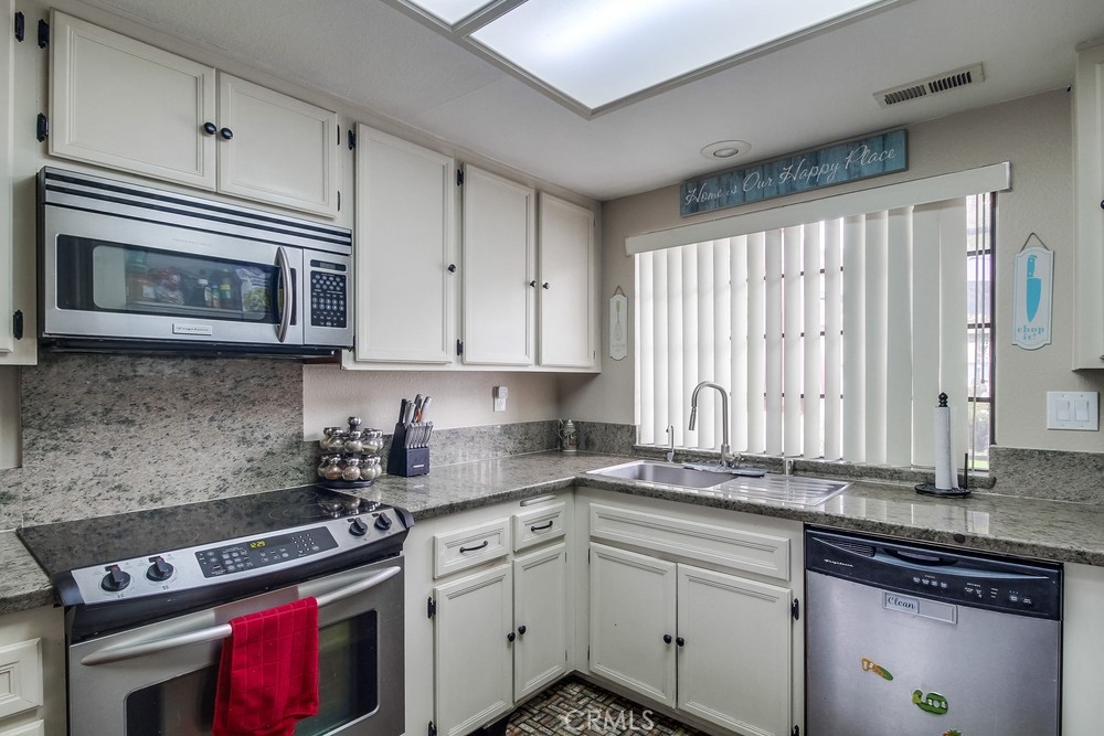 1567 Apache Drive, Unit A Chula Vista, CA 91910 - Photo 13 of 51 a kitchen with granite countertop cabinets stainless steel appliances and a window
