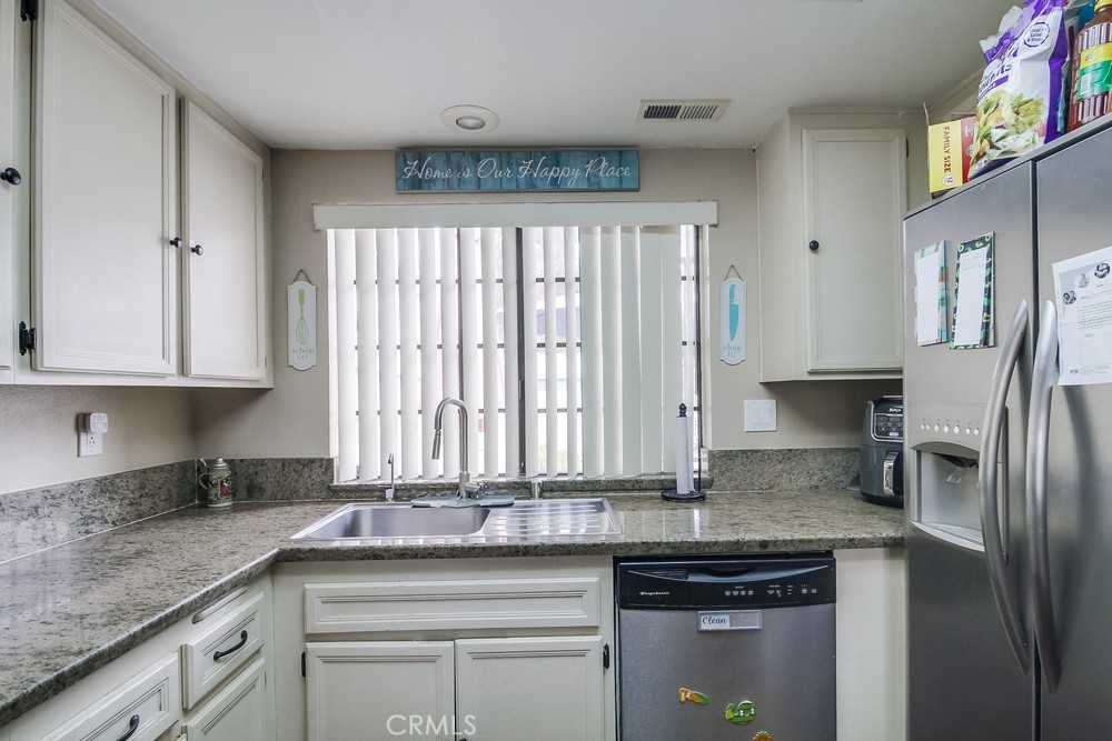 1567 Apache Drive, Unit A Chula Vista, CA 91910 - Photo 14 of 51 a kitchen with stainless steel appliances granite countertop a sink a stove and a refrigerator