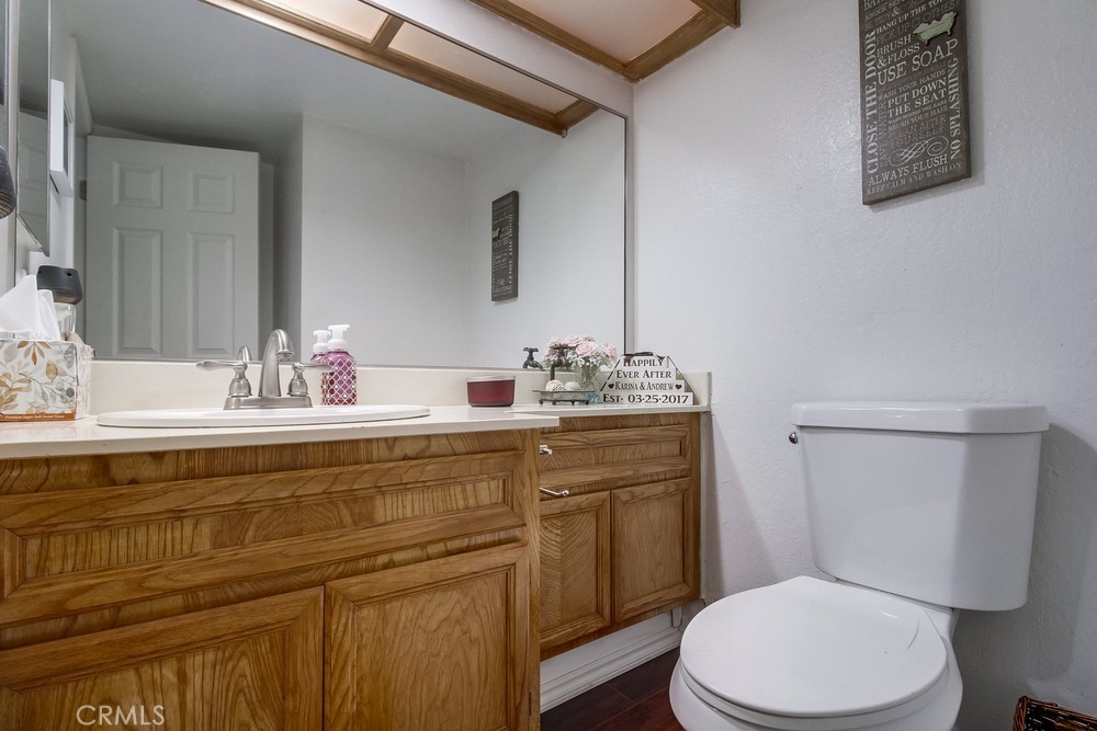 1567 Apache Drive, Unit A Chula Vista, CA 91910 - Photo 16 of 51 a bathroom with a toilet a sink and mirror