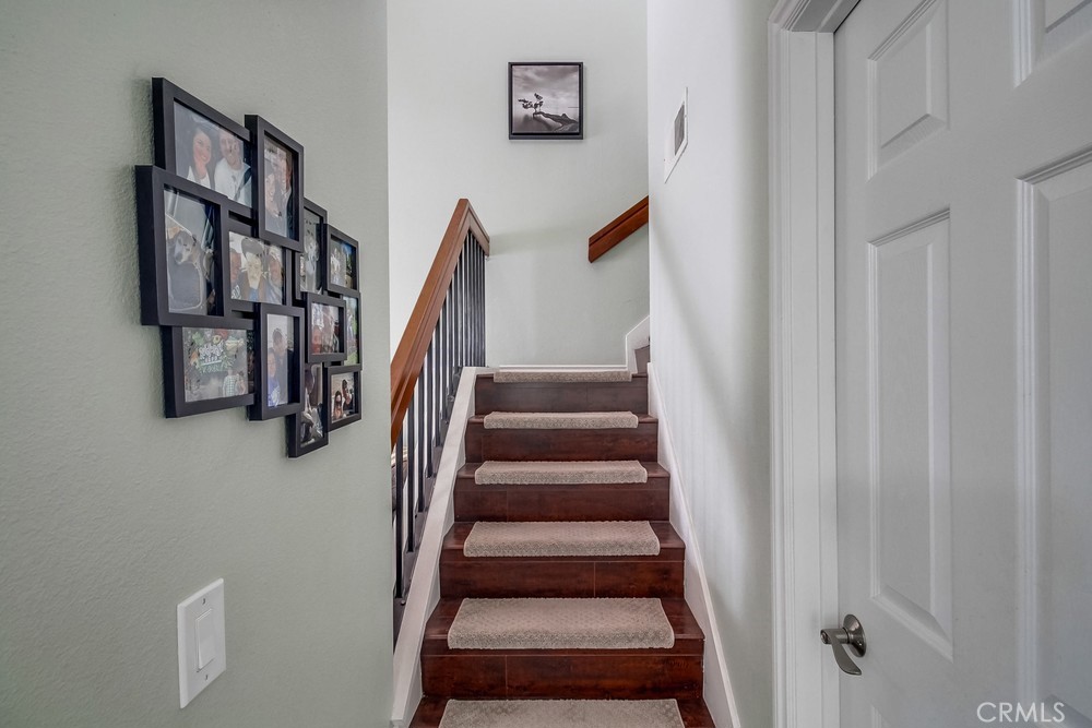 1567 Apache Drive, Unit A Chula Vista, CA 91910 - Photo 17 of 51 a view of staircase with lots of frames on wall
