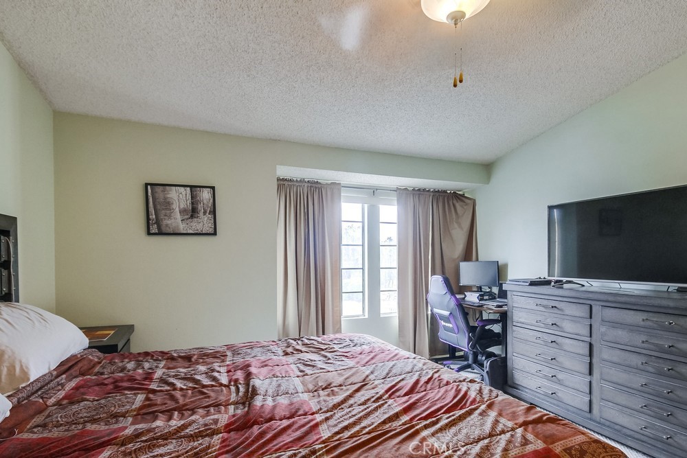 1567 Apache Drive, Unit A Chula Vista, CA 91910 - Photo 19 of 51 a bedroom with a bed and a flat screen tv