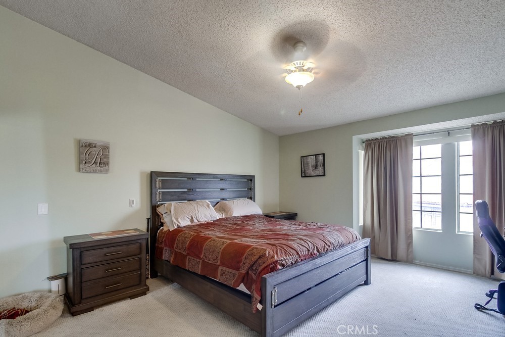 1567 Apache Drive, Unit A Chula Vista, CA 91910 - Photo 20 of 51 a bedroom with a bed and a chandelier