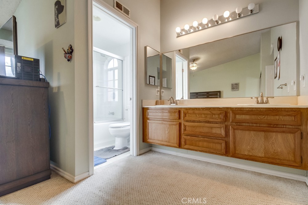 1567 Apache Drive, Unit A Chula Vista, CA 91910 - Photo 25 of 51 a spacious bathroom with a granite countertop sink a toilet a mirror and shower