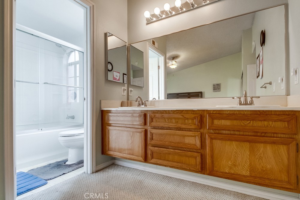 1567 Apache Drive, Unit A Chula Vista, CA 91910 - Photo 26 of 51 a bathroom with a granite countertop sink a toilet and a bathtub
