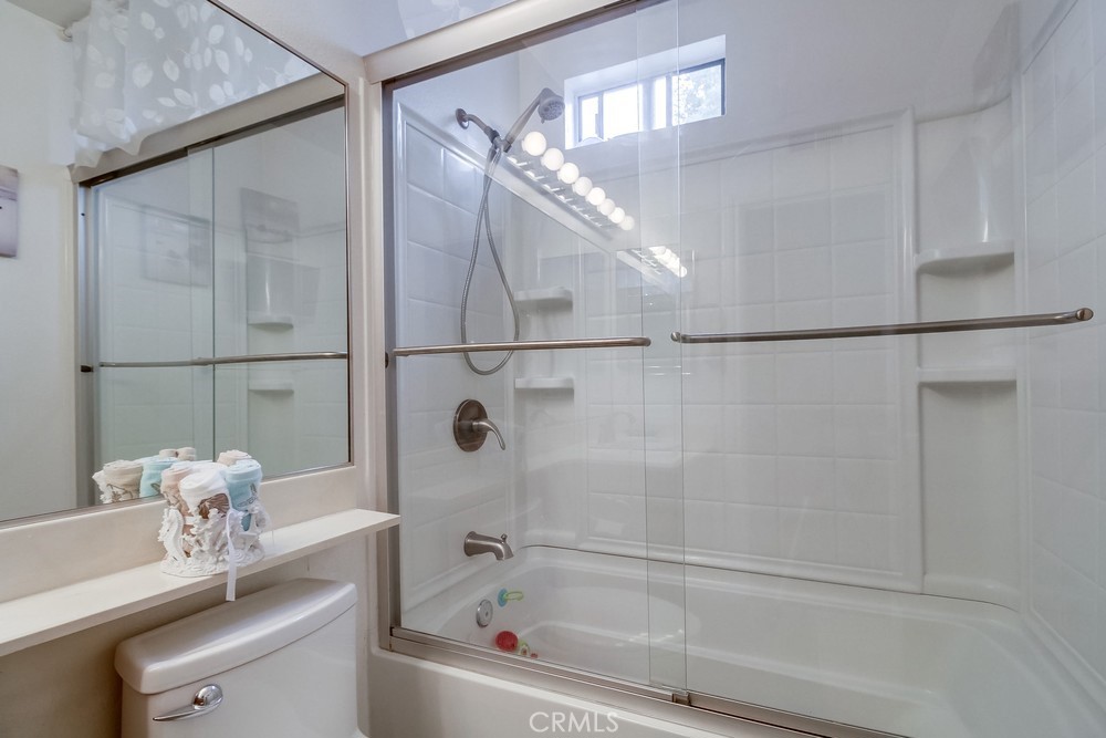 1567 Apache Drive, Unit A Chula Vista, CA 91910 - Photo 31 of 51 a bathroom with a bathtub a mirror and a shower