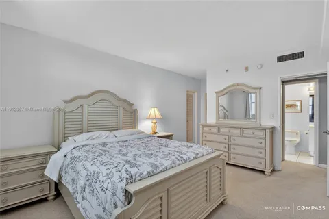 a bedroom with a bed and dresser