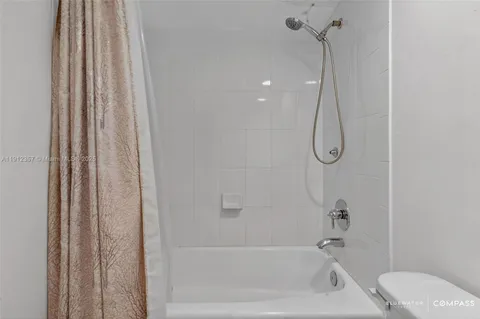 a bathroom with a shower and a shower curtain