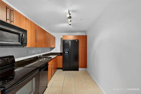 a kitchen with stainless steel appliances granite countertop a stove a refrigerator and a microwave
