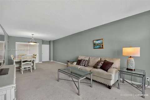 a living room with furniture and a lamp