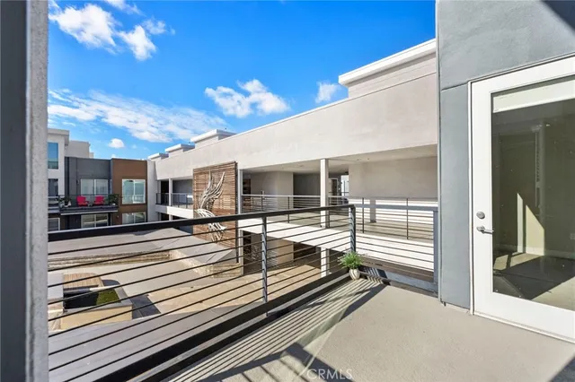 a view of a patio with dining table and chairs with wooden floor