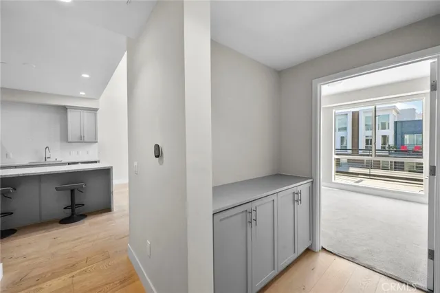a view of cabinets with wooden floor and sink