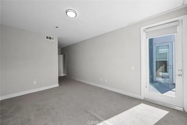 a view of an empty room with glass door