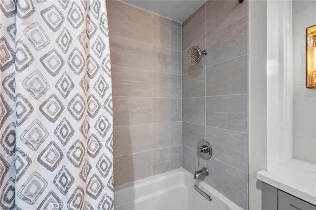 a bathroom with a bathtub and a shower