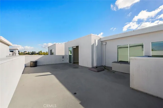 a living room with couches chairs and kitchen view