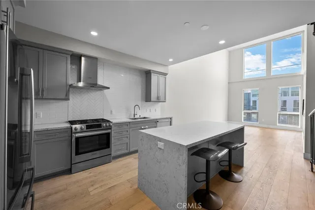 a kitchen with a sink appliances and cabinets