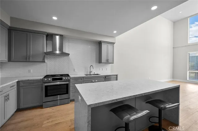 a kitchen with a stove a sink and a microwave