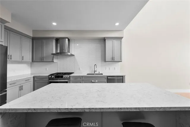 a kitchen with granite countertop a sink a stove and wooden cabinets