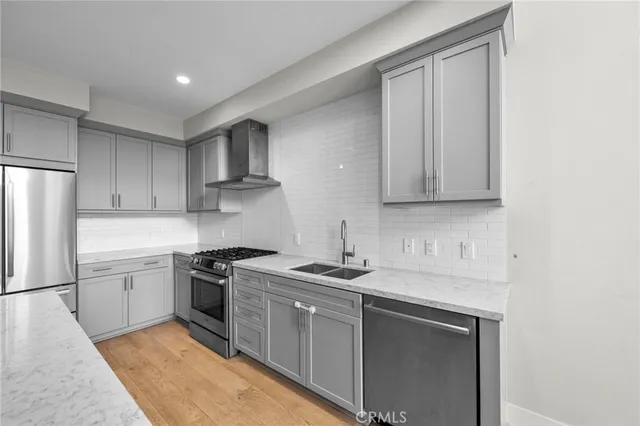a kitchen with white cabinets sink and stainless steel appliances