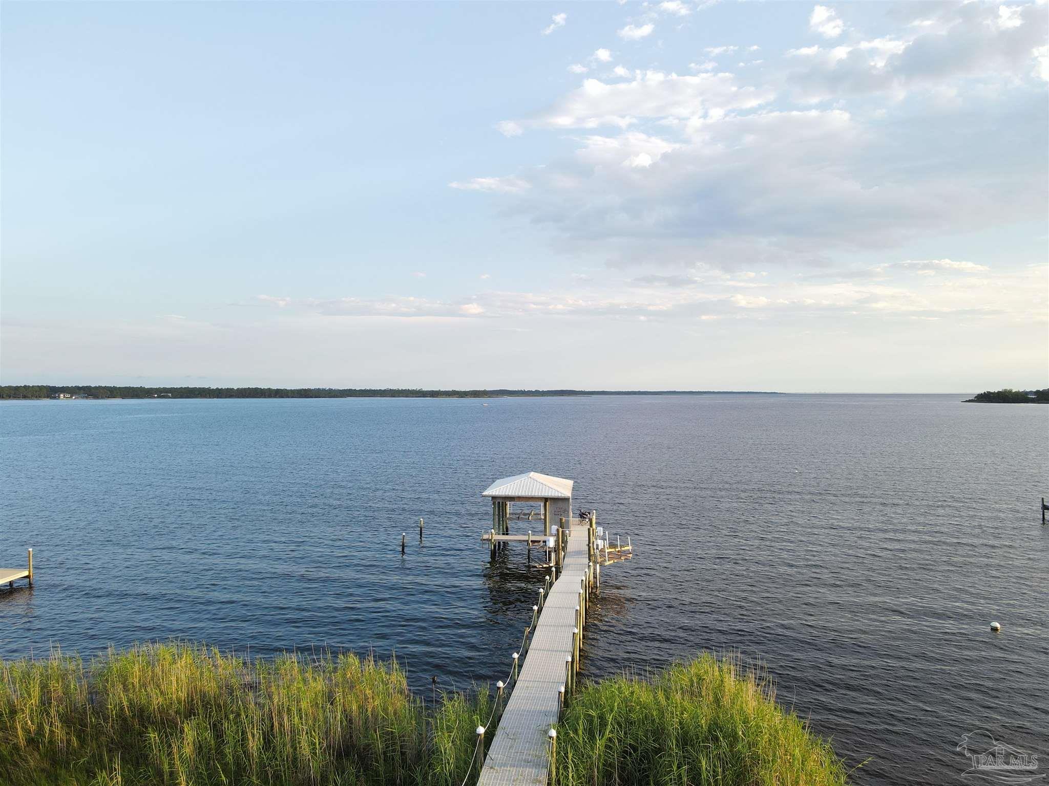 7809 Petersen Point Road Milton, FL 32583 - Photo 11 of 33 a view of floor to ceiling window and wooden floor