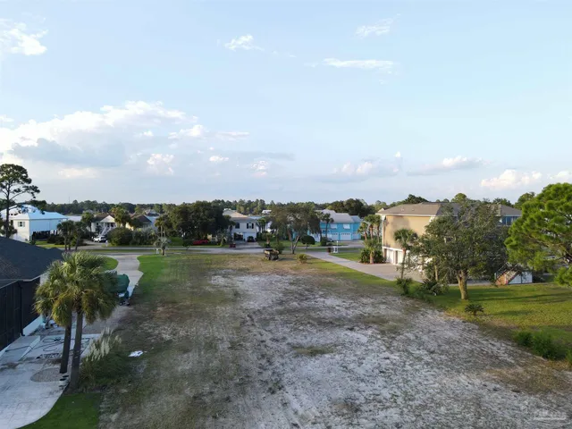 an aerial view of a houses with ocean view