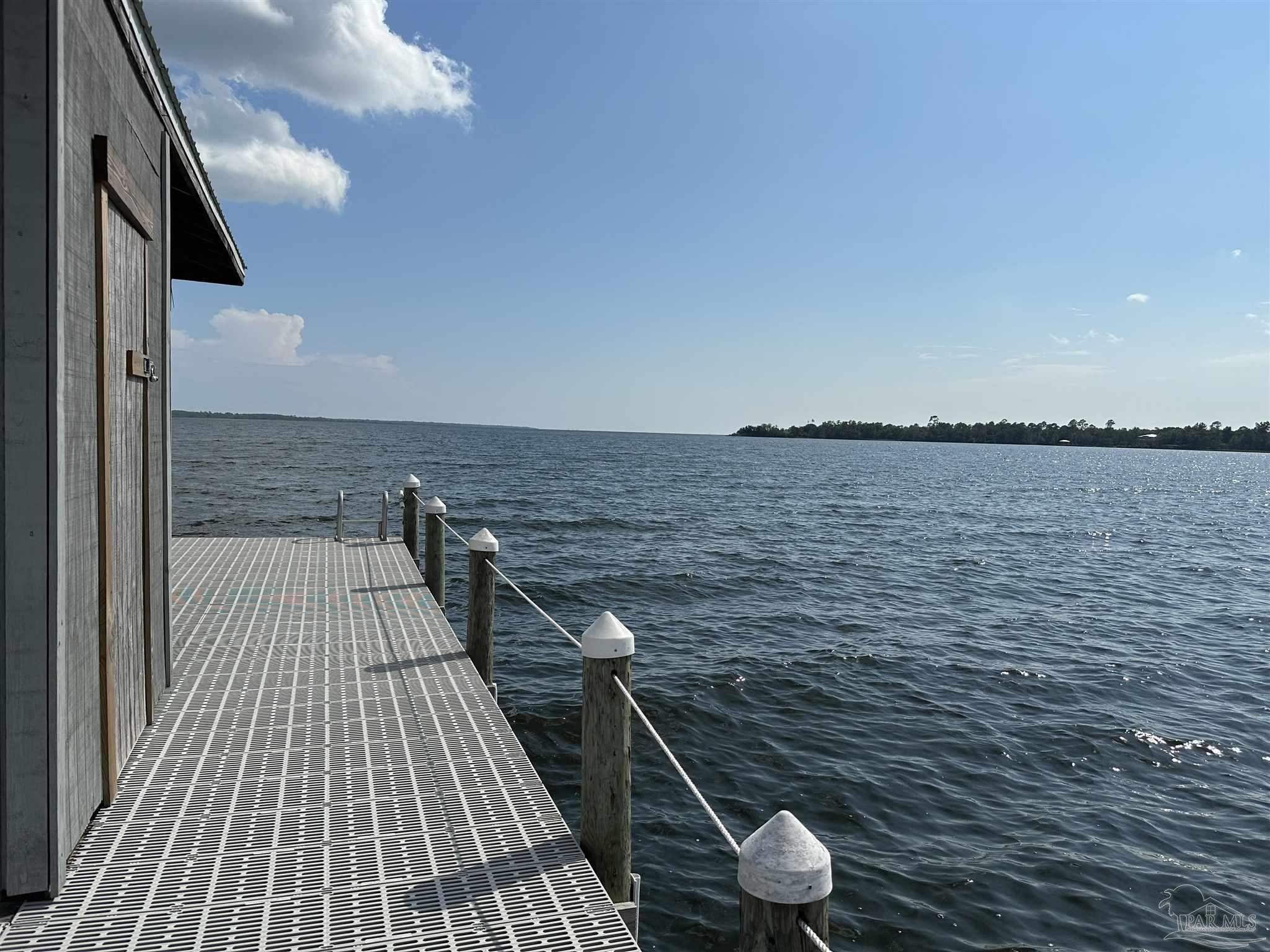 7809 Petersen Point Road Milton, FL 32583 - Photo 19 of 33 a view of balcony with wooden floor