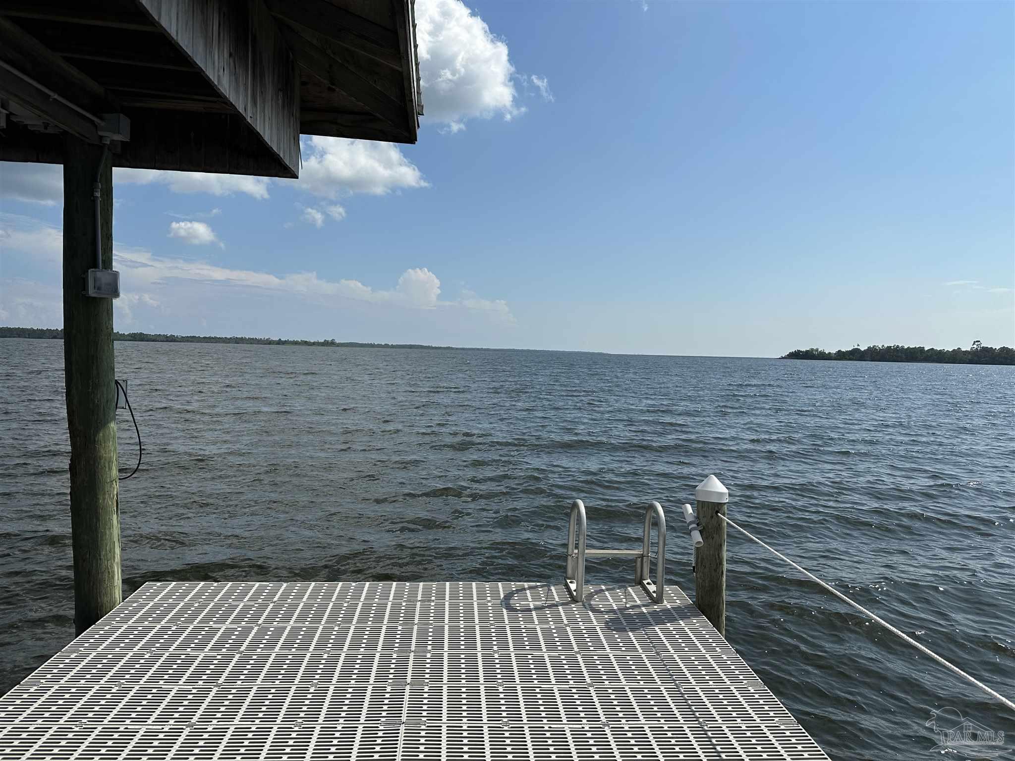 7809 Petersen Point Road Milton, FL 32583 - Photo 20 of 33 a terrace with a wooden floor