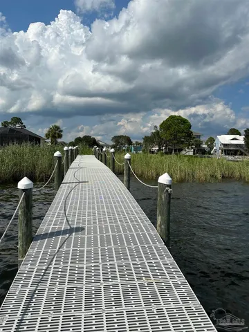 a view of a balcony with a bench and wooden floor