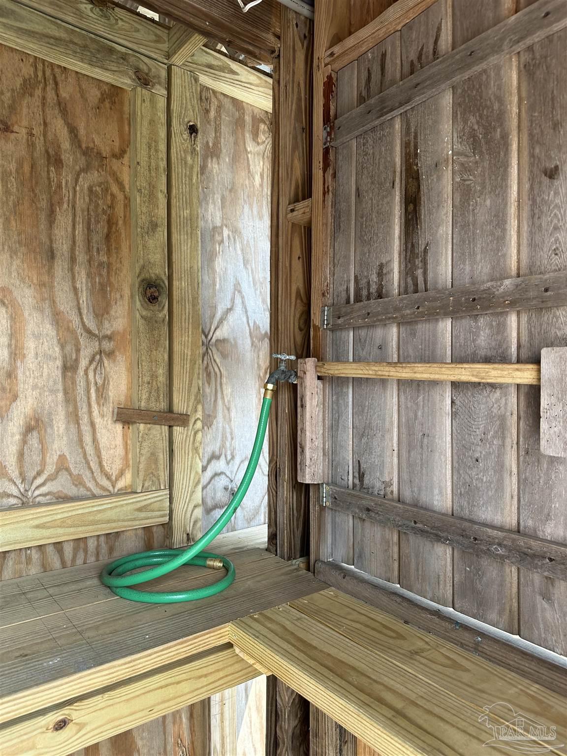 7809 Petersen Point Road Milton, FL 32583 - Photo 24 of 33 a view of a balcony with a bench and wooden floor