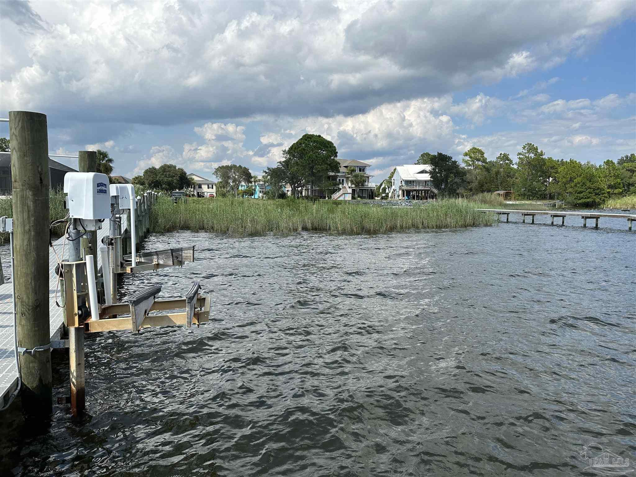 7809 Petersen Point Road Milton, FL 32583 - Photo 26 of 33 a view of a lake with a yard