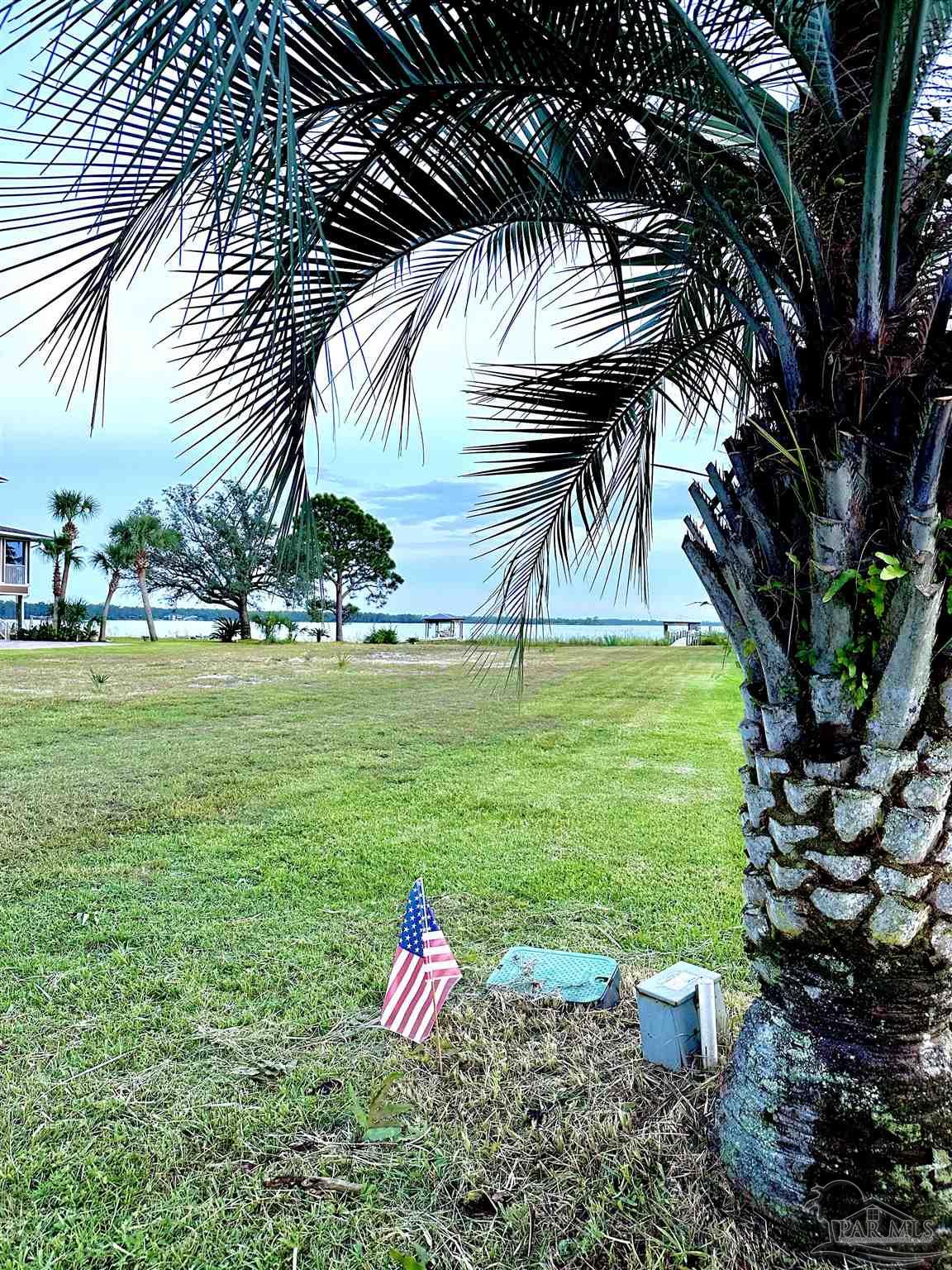 7809 Petersen Point Road Milton, FL 32583 - Photo 31 of 33 a view of a chair and table on the garden