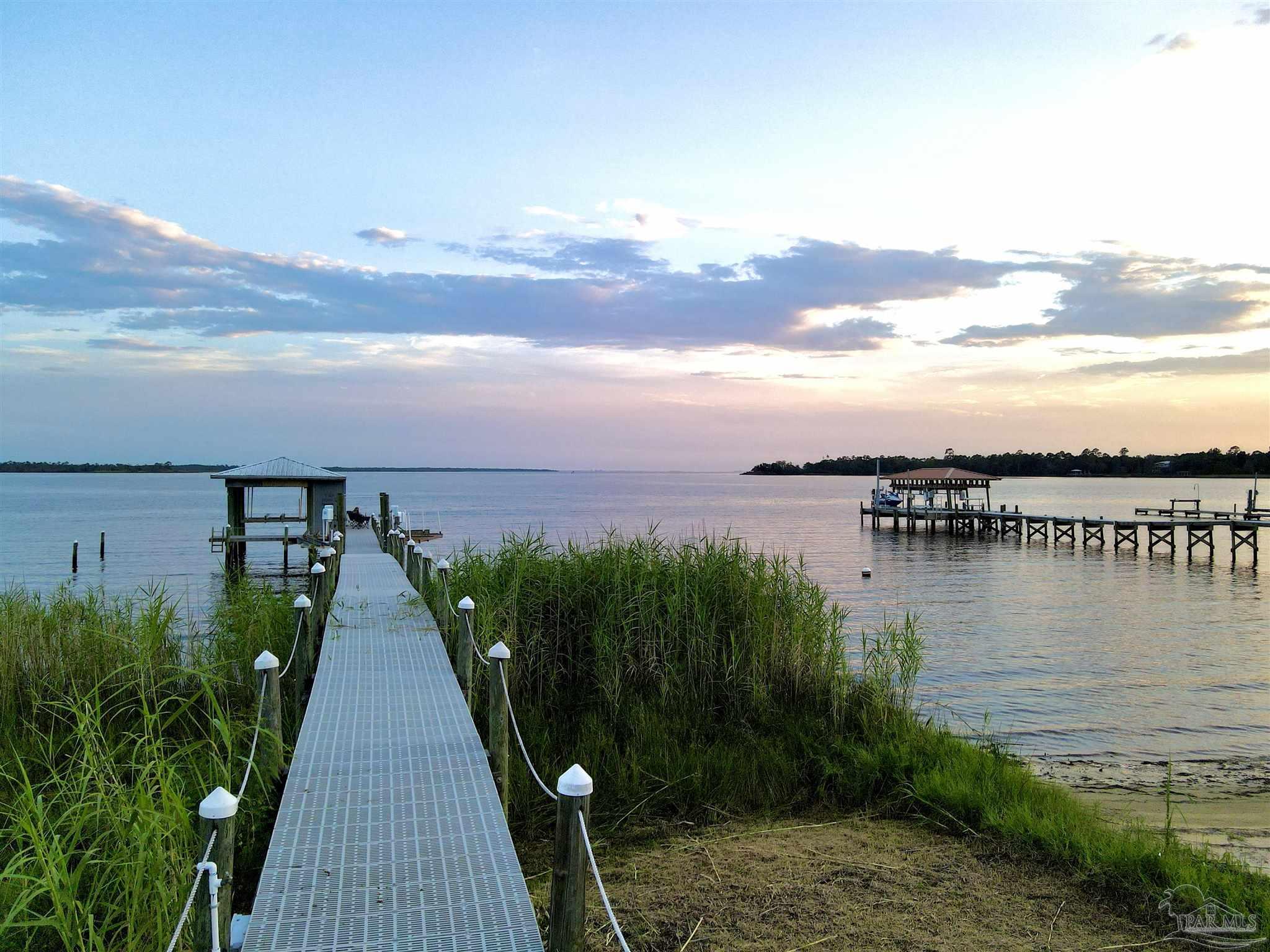 7809 Petersen Point Road Milton, FL 32583 - Photo 4 of 33 a view of a lake with a garden