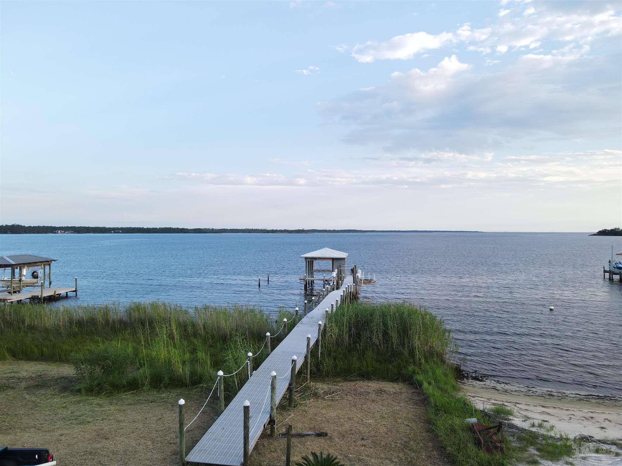 7809 Petersen Point Road Milton, FL 32583 - Photo 6 of 33 a view of a yard and ocean view