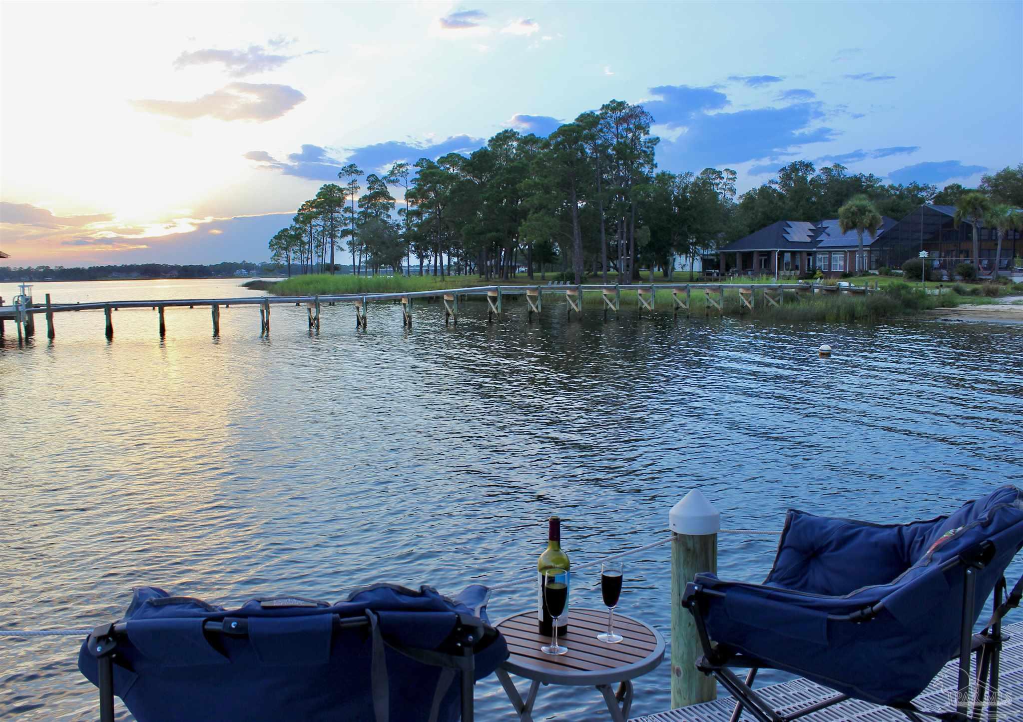 7809 Petersen Point Road Milton, FL 32583 - Photo 7 of 33 a view of a lake with couches chairs