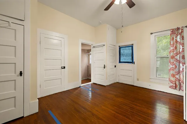 a spacious bedroom with a bed a couch and a window