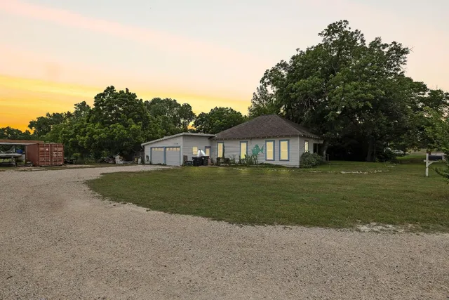 a front view of a house with a garden