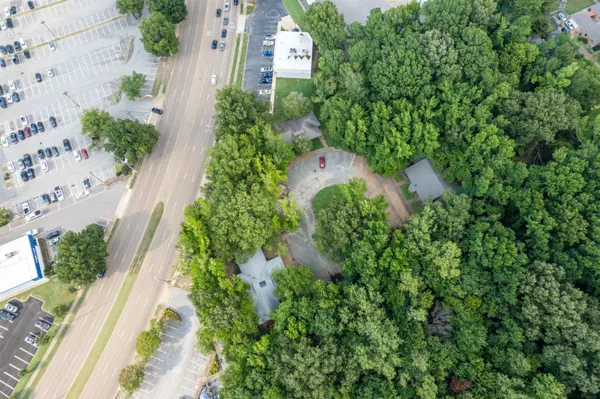 an aerial view of a house with a yard and garden