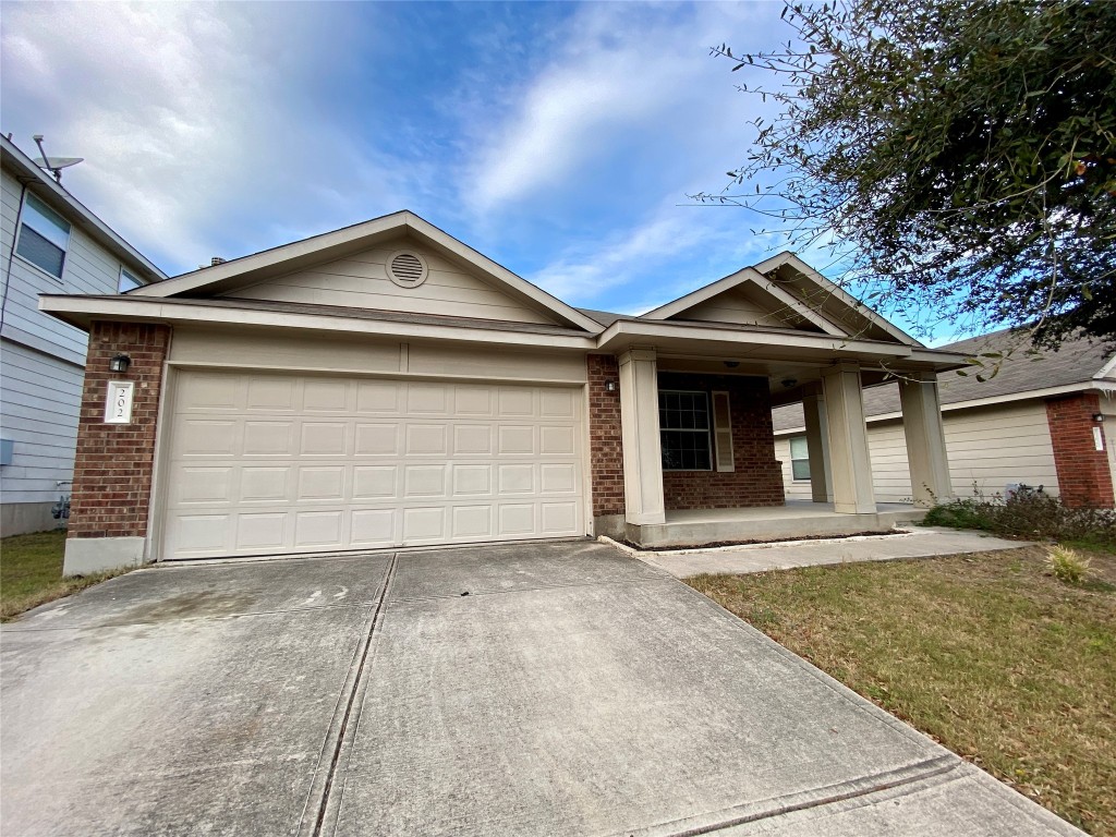 202 Wolfberry Path Buda, TX 78610 - Photo 1 of 1 a front view of a house with a yard and garage
