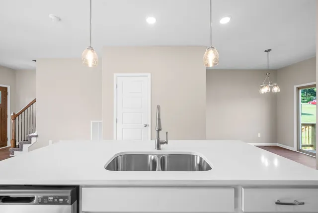 a kitchen with a sink a counter space and a window