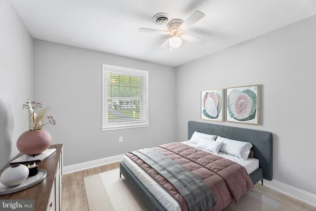 a bedroom with a bed and painting on the wall