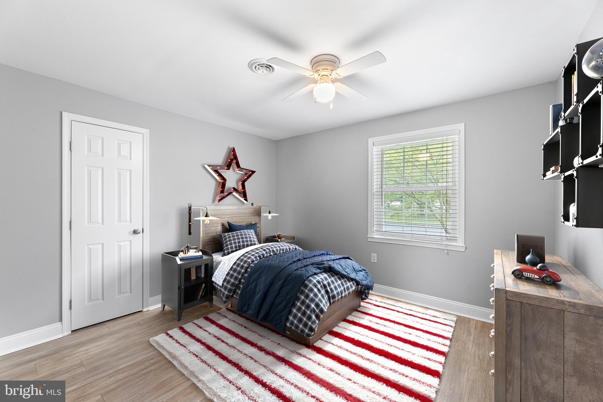 7384 Brett Road Easton, MD 21601 - Photo 18 of 29 a bedroom with a bed and a chandelier