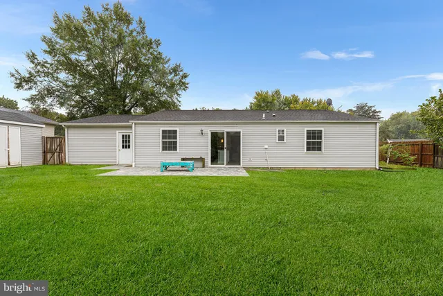 a front view of house with a garden