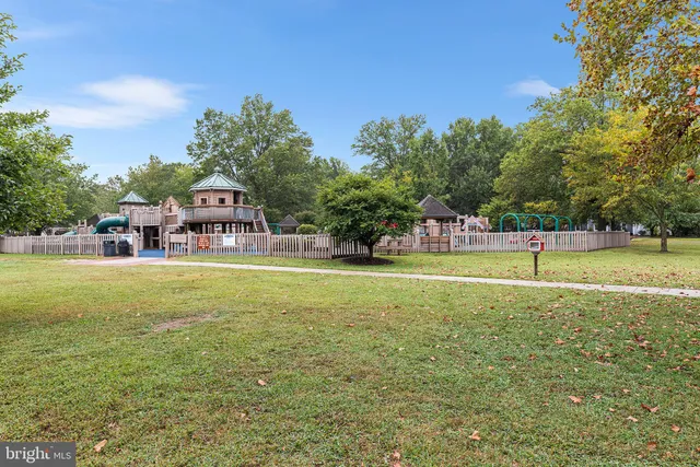 a house view with swimming pool and trees in the background